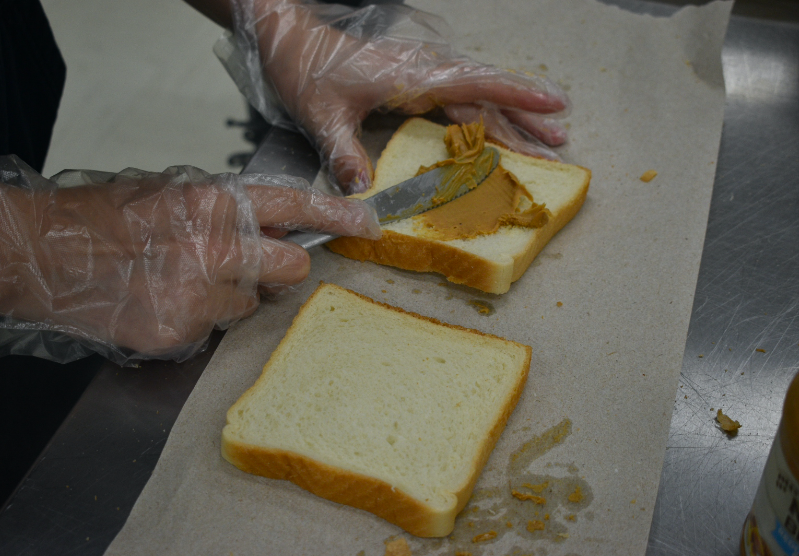 A single sandwich being made with peanut butter